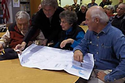 Hy Brodsky, John Chimples, Arlene Brodsky, and Carl Reimerdes of the Montauk Citizens Advisory Committee looked over plans submitted by Dr. Molly Miosek, a veterinarian, for an animal clinic that she would like to build on her property on Essex Street that would require a zoning change from the Town of East Hampton.