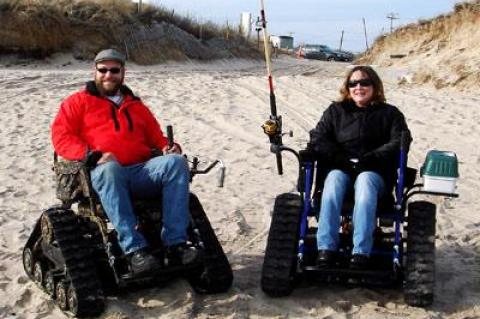 Larry Keller Jr., left, is the exclusive agent for the all-terrain wheelchair without wheels called the Action Trackchair. On Saturday at Ditch Plain, his girlfriend, Sharyn Marks, showed off the chair’s surfcasting potential.