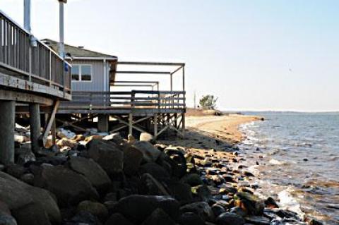 The East Hampton Zoning Board of Appeals is considering an application to tear down and rebuild a house on Mulford Lane in Amagansett, along with the construction of a rock revetment to prevent further erosion.