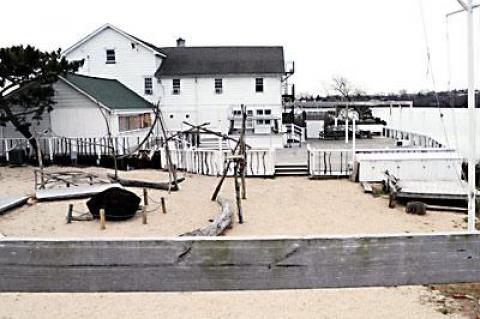 The Surf Lodge is appealing the senior building inspector, Tom Preiato’s, determination that the food cart and the covered wait service area, back right, are an expansion of a nonconforming use. Both structures require a natural resources special permit and a variance since Fort Pond is at the edge of the deck.