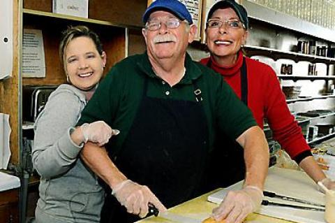 A week of warm farewells have descended upon Bucket’s owner, Everett Griffiths, seen here in the embrace of a longtime employee, Tammi Gay, and Mr. Griffith’s wife, Angela.