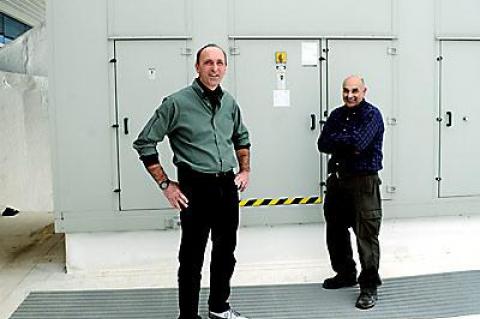 Eric Woellhof, the director of facilities, seen here on the high school roof with Anthony DeFino, a colleague, has instigated initiatives that have led to the district receiving a rebate from the Long Island Power Authority.