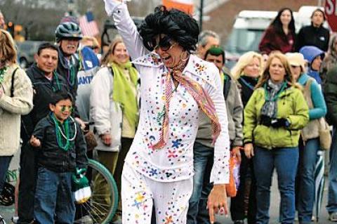 Nothin’ but a hound dog. One of the Elvises posed for the crowd at Sunday’s St. Patrick’s Day parade.