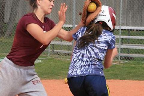 School of Hard Knocks: Lia Makrianes, a freshman, who was taken onto the varsity this spring, found herself frequently confronted at the plate by Kathryn Hess, the senior catcher, during Saturday morning’s practice.