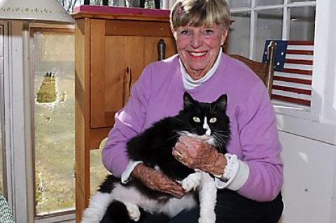 Joan Tulp with a furry friend in her Gansett Lane living room.