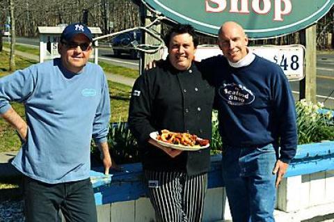 Alex Fausto and Paul LaBue joined Colin Mather, the owner of the Seafood Shop, in presenting a paella dish, one of the shop’s most popular classics. Mr. LaBue will soon be enhancing the menu with additional international dishes.