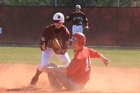 A rare sight: an Amityville player sliding safely into second in the first game of April 9’s doubleheader here.