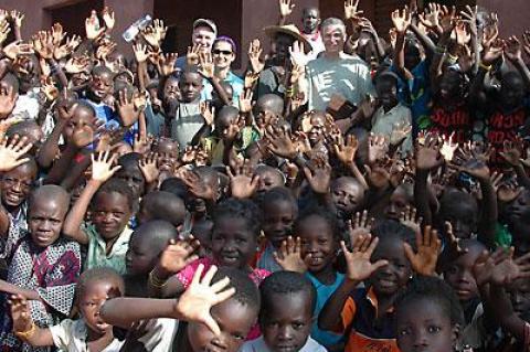 Fred Doss, John Gicking, and Shirin Kerman, rear, at a buildOn school site in Mali in 2006, surrounded by children who had never been to school in a proper building before.