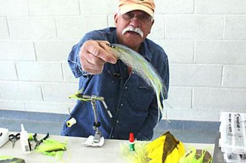 During the Sportsmen’s Expo held at the Amagansett Firehouse on Saturday, Alfonso Marino displayed a fly he’s tied to lure big striped bass.