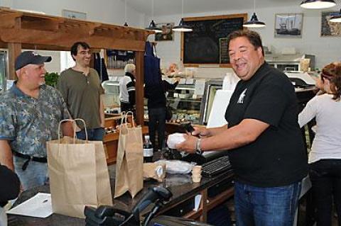 Hampton Seafood’s owner, Peter Ambrose, serves up to-go dishes like duck tacos, made-to-order sushi rolls, and other daily selections at the new store on Race Lane in East Hampton.