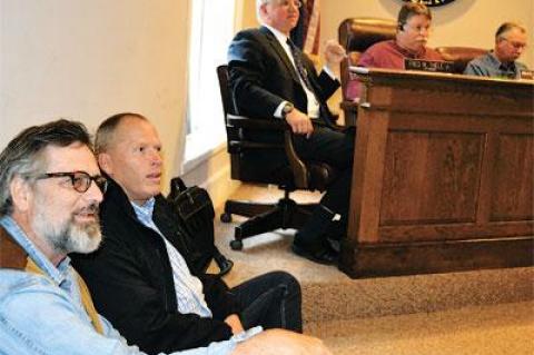 Anton Hagen and Brendan Skislock sat on the floor near Assemblyman Fred W. Thiele Jr., and the board members Bruce Stafford and Edward Gregory at Tuesday’s hearing on a law that would allow ferries to dock in the village.