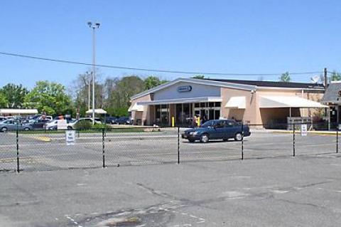 The owners of the Amagansett I.G.A. have put up a fence to protect their parking lot from potential future neighbors.