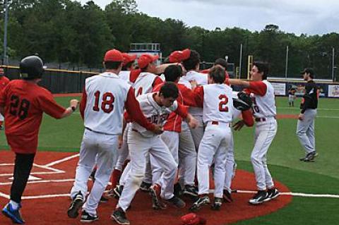 How sweet it was: The freshman pinch-runner, Jack Fitzpatrick, was mobbed after scoring the game-winning run in the bottom of the seventh.