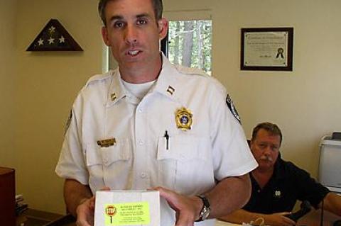 Capt. Michael Sarlo, of the East Hampton Town police, with Chief Edward Ecker Jr., rear, displayed a blood test kit of the type used on driving-while-intoxicated suspects after they are arrested.