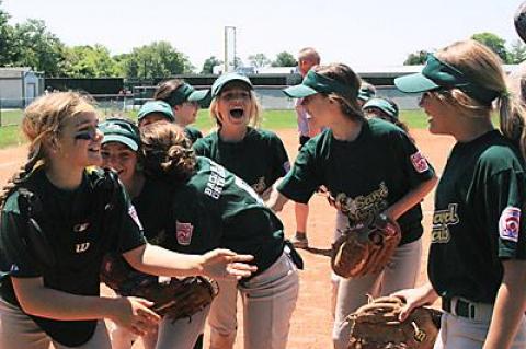 The Sand Gnats jumped around after winning the Little League girls softball “world series.”