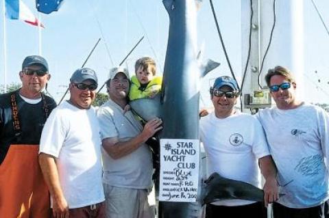 The crew of the P Pod posed with the 237-pound blue shark that took first place in the blue shark division of the Star Island Yacht Club’s shark tournament over the weekend.