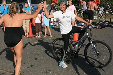 Ana Jacobs, who did the bike leg of a relay team whose other members were Kim Notel and Eric Casale, the Springs School’s principal, exchanged a high-five with a swimmer as she set out.