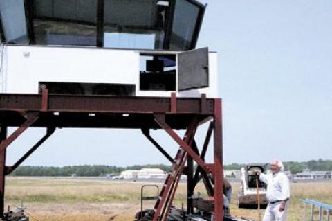 Air traffic controllers will be on the job tomorrow morning in the new control tower at East Hampton Airport, directing traffic in and out of the airport between 7 a.m. and 11 p.m. each day. Town Councilman Dominick Stanzione, at right, coordinated the effort to gain federal approval for the tower and get it in place.