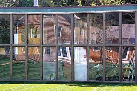 Reflections in the glass wall of the late Costantino Nivola’s studio offer a playful look at the house, which his son moved and reconstructed.