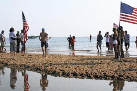 Griffin Taylor, of New York City and Montauk, winner of the one-mile swim, was the first of the some 170 participants to exit the water.