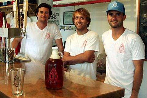 The brains behind the brew at the new Montauk Brewing Company, from left, Joe Sullivan, Eric Moss, and Vaughan Cutillo, worked the tap at the brewery off Edgemere Street on Sunday.