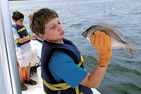 Mason Cohen of Water Mill greeted a porgy up close and personal during an outing provided by the Flying Point Surf School’s fish camp last week.