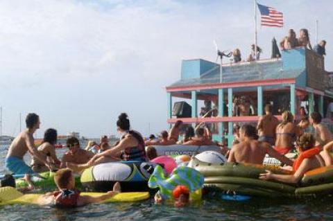 Revelers surrounded a floating stage at an annual boat party Sunday afternoon near Sag Harbor.