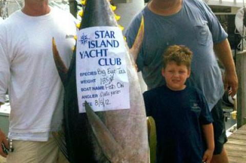 Chris Yates, left, caught this 185-pound (dressed weight) big-eye tuna from Capt. Peter Brancaleone’s Fish On boat on Sunday with the help of mate Peter Brancaleone Jr. The tuna was weighed in at the Star Island Yacht Club.