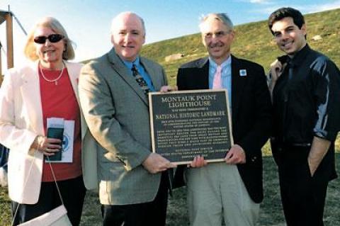 With the presentation of a plaque at a party on Aug. 22, the Montauk Lighthouse officially became a National Historic Landmark. At the event were, from left, Eleanor Ehrhardt of the Lighthouse committee, Robie S. Lange, historian of the National Parks Service, Robert J. Hefner, a historic preservation consultant who worked with Ms. Ehrhardt to receive the recognition, and Scott Martella of Gov. Andrew M. Cuomo’s office.