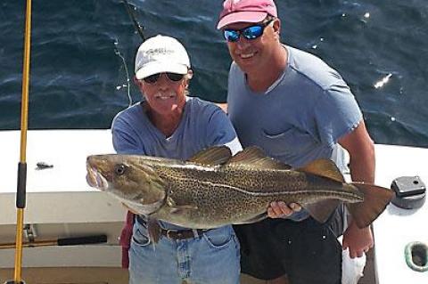 Butch Maher, left, first mate on the charter boat Blue Fin IV, showed off the 25-pound cod caught by the angler Robert Macbarb of East Hampton on Sunday.