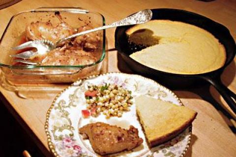 Skillet cornbread, Vietnamese chicken, and fresh corn salad on a dainty plate is one way of “roughing it” in a house devoid of kitchen supplies.