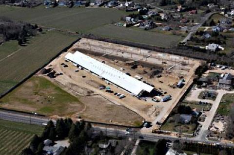 The new Parrish Art Museum is only weeks away from opening to the public and days away from the staff’s moving into new offices. An aerial view shows the museum in an earlier state. At top, two views of the gallery spaces in the Water Mill building.