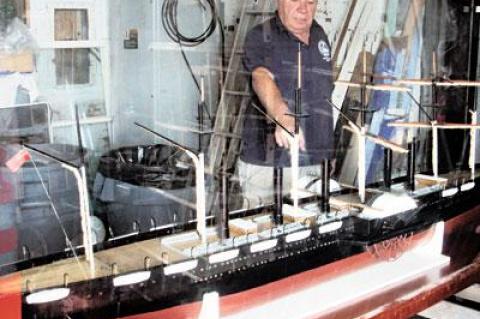 Brian Pope, assistant site manager of the Montauk Lighthouse Museum, pointed to one of two side wheels on a scale model of the S.S. Great Eastern purchased by the museum in August. The model is being readied for display.