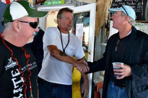 Charlie Canavan, right, thanked the owner of Billy’s on the Bay in Greenport on Saturday, one stop on his Sag Harbor Hysterical Society boat poker run.