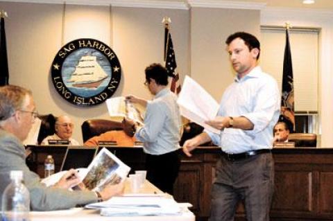 David Kronman, center, and Curtis Bashaw of Cape Advisors distributed revised plans for the renovation of the Baron’s Cove Inn and the addition of a second floor restaurant.