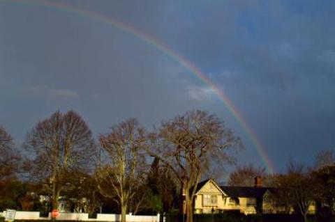 Tuesday’s clearing sky briefly lit up with a rainbow, seen over the Baker House inn in East Hampton Village.