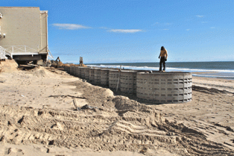 More than a dozen concrete drainage “rings” have been buried on the Montauk beach in front of the Royal Atlantic and Ocean Beach motels, after storm-induced erosion threatened buildings. East Hampton Town officials are investigating the work, as a permit issued specified only the placement of sand.