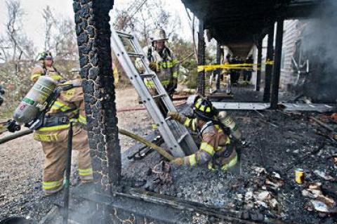 A volunteer firefighter emerged from a lower level at the Sea Crest motel on Napeague following a fire there on Nov. 7 that destroyed several units.