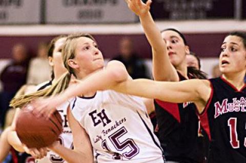 Carley Seekamp, with the ball, was a great help on the boards and also chipped in with 8 points here Friday night.