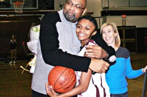 With her sister, Tiffany, looking on, Kaelyn Ward was embraced on the occasion of her 1,000th point by her coach, Howard Wood.