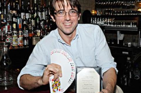 Michael Dollar, the bartender/magician at the Vine Street Cafe on Shelter Island, performs card tricks for well-behaved patrons. He also reads auras and has concocted his own specialty drinks menu.