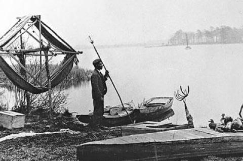 Thomas Hill with eel spear and fishing equipment in a photo taken by Francis Harper in 1910.