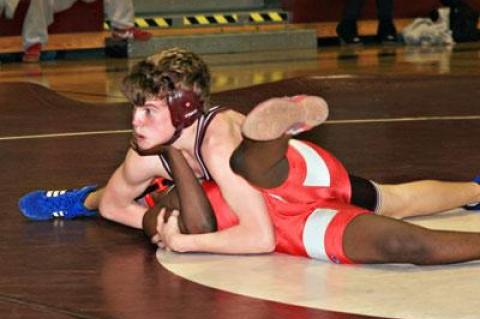 Kevin Boles checked with his coaches moments before he was declared the winner by pin at 112 pounds.