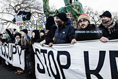 Dan Asselin, second from right, served as a volunteer bus organizer for Forward on Climate, a rally to combat climate change held in Washington, D.C., on Sunday.