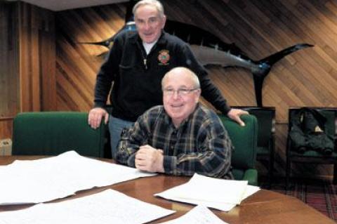 Montauk Fire Chief Rich Schoen, standing, looked at maps that Peter Joyce, a fireman and former chief, has identified as being among the most vulnerable to damage should a storm like Hurricane Sandy hit Montauk.