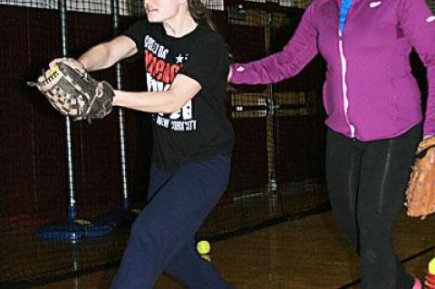 Ali Harden may be on the mound at times this season. Jessie Stavola offered assistance during Saturday’s practice in the high school gym.