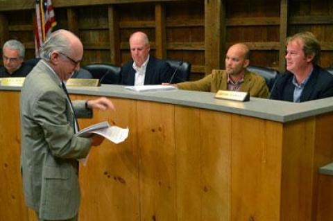 David Lys, the  newest member of the East Hampton Town Zoning Board of Appeals was handed documents by Jeffrey Bragman during his first public hearing. From left were Don Cirillo, Mr. Bragman, Alex Walter, the board’s chairman, Mr. Lys, and Bryan Gosman.