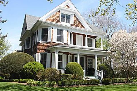 This Southampton Victorian-era house has some classic Queen Anne-style features on its exterior, including a front porch and a second-floor porch, prominent gables, an asymmetrical form, and bay windows.