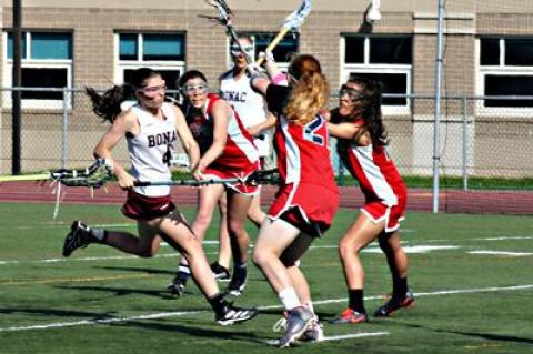 Maggie Pizzo, at left, scored four goals and had six assists in East Hampton’s 19-7 win here on May 7 over Bellport.