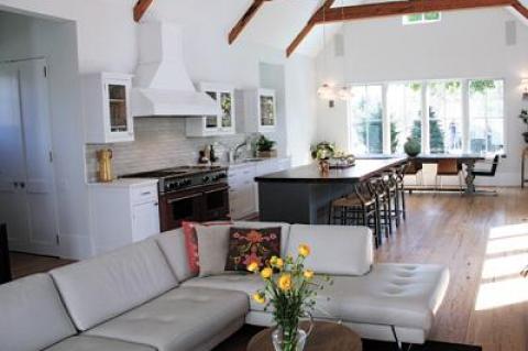 Long-leaf yellow pine beams and flooring, collected by Bryan Gosman, imbue the open living area with warmth.